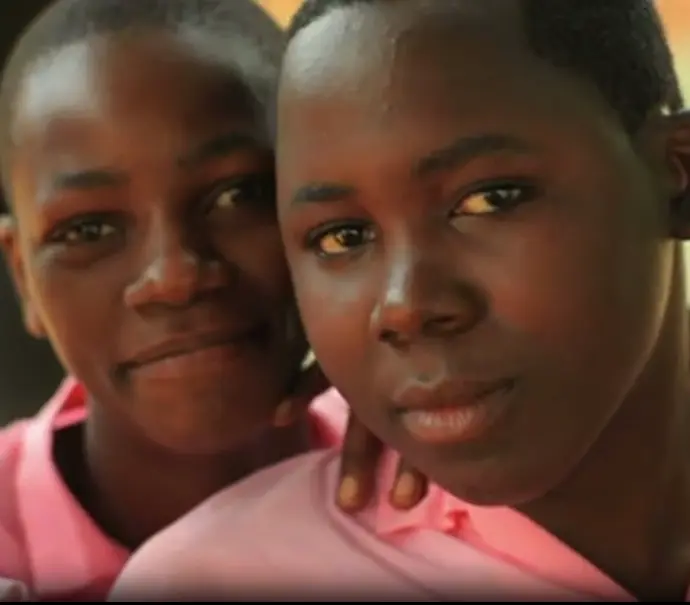 Two young girls posing for an up close photo.