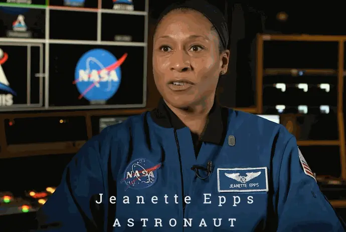 Black woman sitting in a NASA uniform.