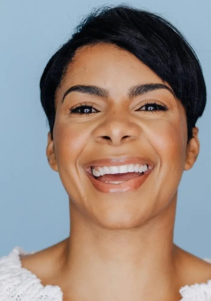An up close photo of a woman smiling.