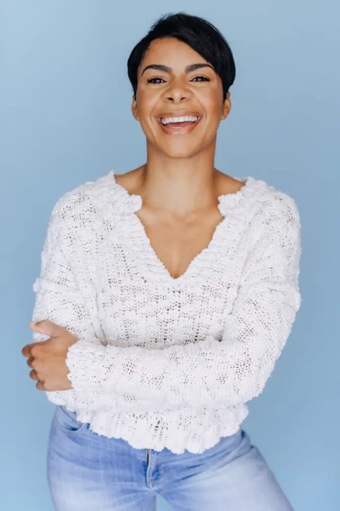 A woman smiling and looking into the camera.