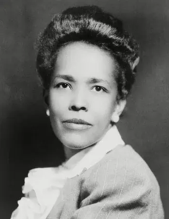 A black and white portrait of a Black woman in 1940s.