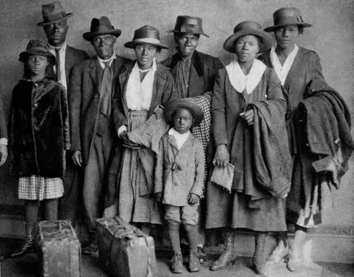 A Black family posing for a formal photograph.